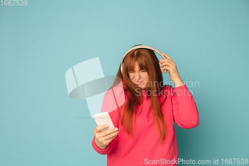 Image of Caucasian woman\'s portrait isolated on blue studio background with copyspace