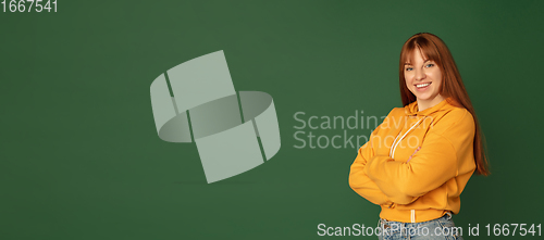 Image of Caucasian woman\'s portrait isolated on green studio background with copyspace, horizontal flyer