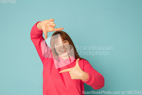 Image of Caucasian woman\'s portrait isolated on blue studio background with copyspace