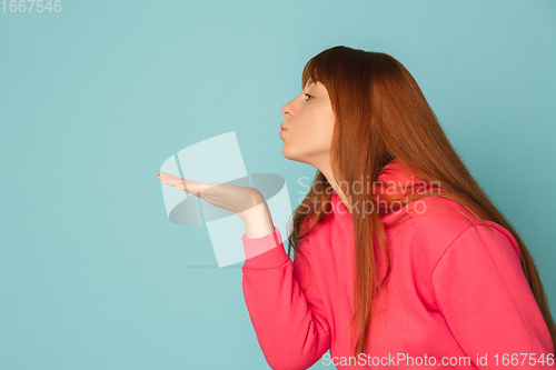 Image of Caucasian woman\'s portrait isolated on blue studio background with copyspace