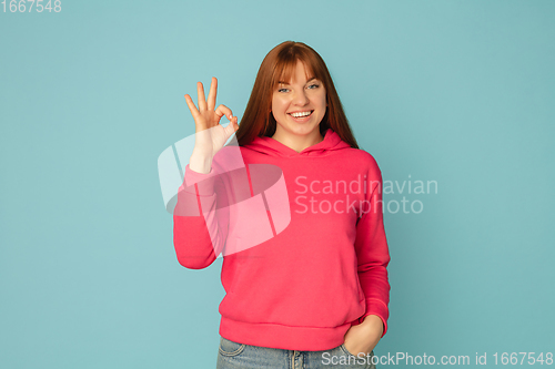 Image of Caucasian woman\'s portrait isolated on blue studio background with copyspace