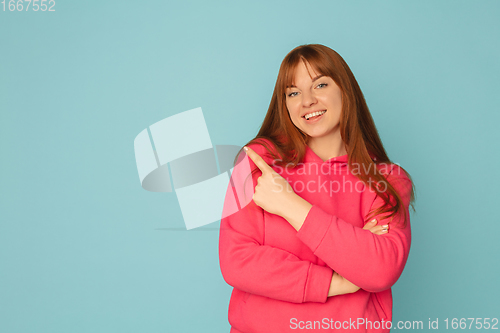 Image of Caucasian woman\'s portrait isolated on blue studio background with copyspace