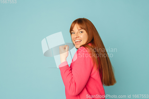 Image of Caucasian woman\'s portrait isolated on blue studio background with copyspace