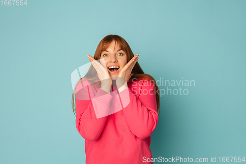 Image of Caucasian woman\'s portrait isolated on blue studio background with copyspace