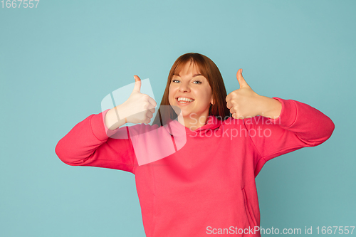 Image of Caucasian woman\'s portrait isolated on blue studio background with copyspace