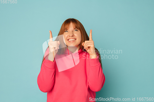 Image of Caucasian woman\'s portrait isolated on blue studio background with copyspace