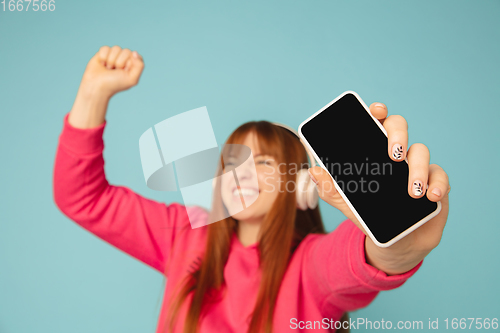 Image of Caucasian woman\'s portrait isolated on blue studio background with copyspace