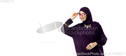 Image of Beautiful arab woman posing in stylish hijab isolated on studio background. Fashion concept