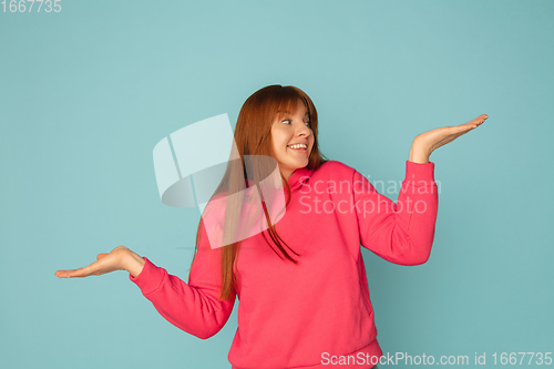 Image of Caucasian woman\'s portrait isolated on blue studio background with copyspace