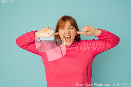 Image of Caucasian woman\'s portrait isolated on blue studio background with copyspace