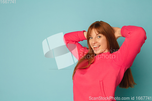 Image of Caucasian woman\'s portrait isolated on blue studio background with copyspace