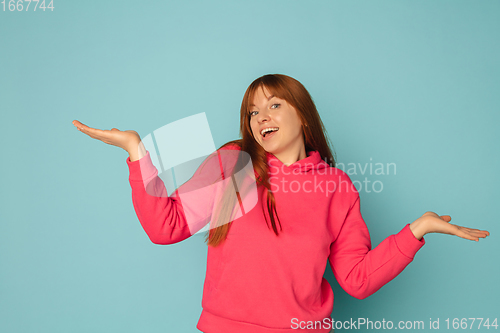 Image of Caucasian woman\'s portrait isolated on blue studio background with copyspace