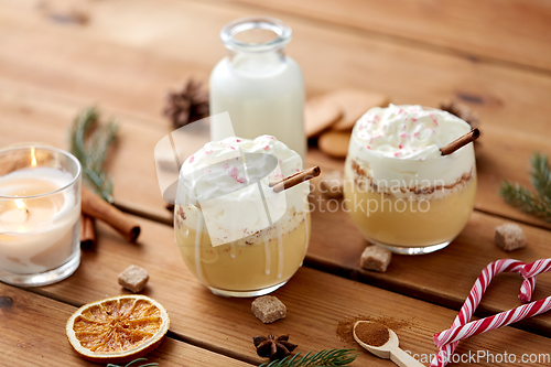 Image of glasses of eggnog with whipped cream and spices