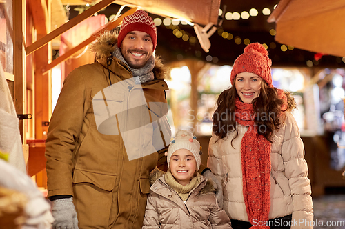 Image of happy family at christmas market in city