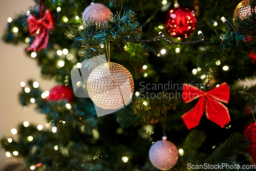 Image of golden christmas ball decoration on fir tree