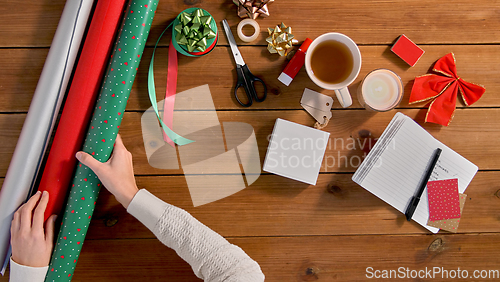Image of hands setting stuff for christmas gifts wrapping