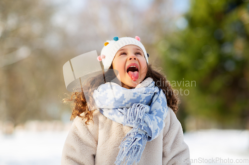 Image of happy little girl having fun at winter park