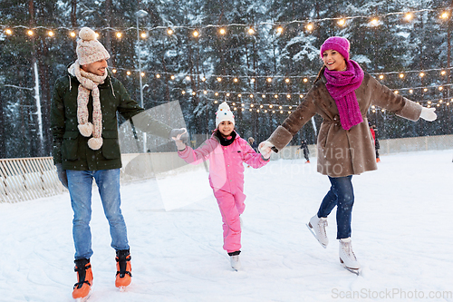 Image of happy family at outdoor skating rink in winter