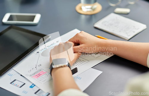 Image of hands with mockup working on ui design at office