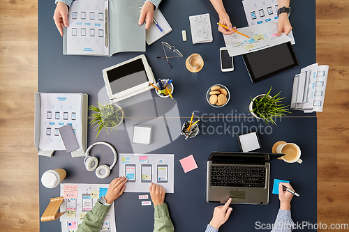 Image of business team with gadgets working at office table