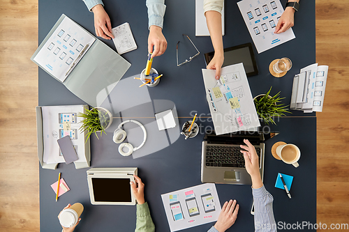 Image of business team with gadgets working at office table