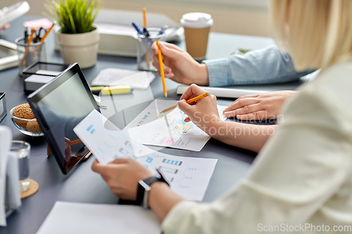 Image of business team with gadgets working at office table