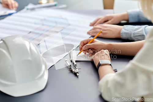 Image of architect with notebook working at office