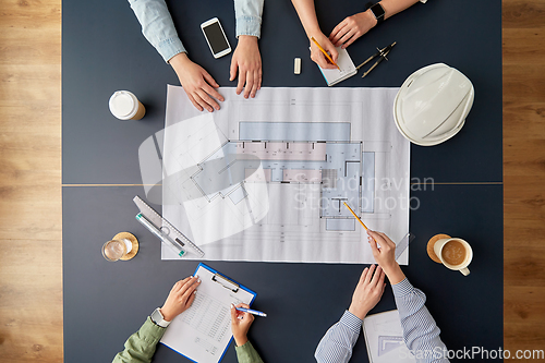 Image of business team with blueprint working at office