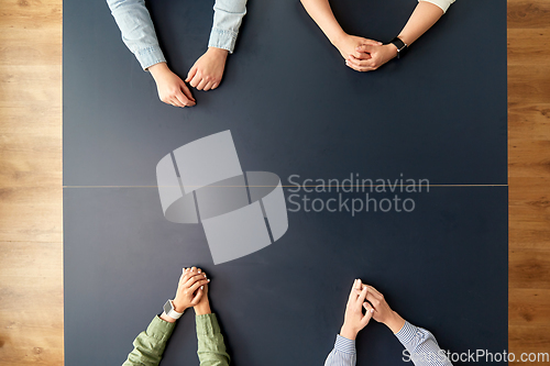 Image of business team sitting at office table
