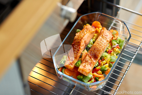 Image of food cooking in baking dish in oven at home