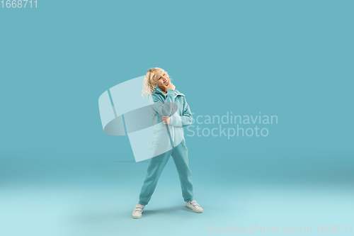 Image of Childhood and dream about big and famous future. Pretty curly boy isolated on blue background