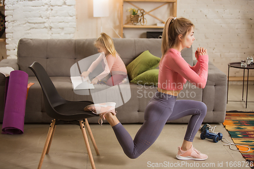 Image of Young woman exercising fitness, aerobic, yoga at home, sporty lifestyle. Getting active with her child playing, home gym.