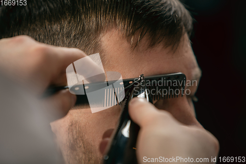 Image of Close up of client of master barber, stylist during getting care