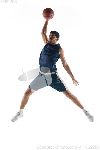 Image of Young arabian basketball player of team in action, motion isolated on white background. Concept of sport, movement, energy and dynamic.