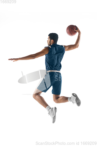 Image of Young arabian basketball player of team in action, motion isolated on white background. Concept of sport, movement, energy and dynamic.