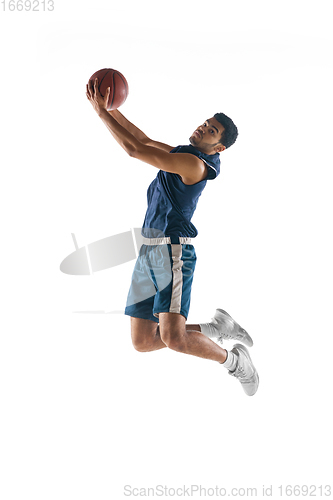 Image of Young arabian basketball player of team in action, motion isolated on white background. Concept of sport, movement, energy and dynamic.