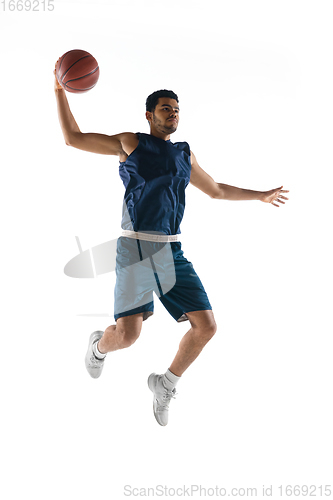 Image of Young arabian basketball player of team in action, motion isolated on white background. Concept of sport, movement, energy and dynamic.