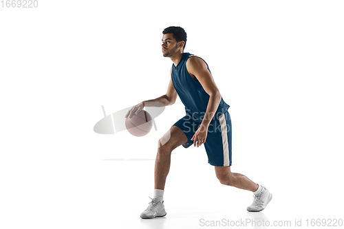 Image of Young arabian basketball player of team in action, motion isolated on white background. Concept of sport, movement, energy and dynamic.