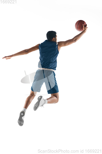 Image of Young arabian basketball player of team in action, motion isolated on white background. Concept of sport, movement, energy and dynamic.