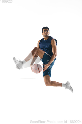 Image of Young arabian basketball player of team in action, motion isolated on white background. Concept of sport, movement, energy and dynamic.