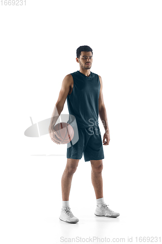 Image of Young arabian basketball player of team posing isolated on white background. Concept of sport, movement, energy and dynamic.