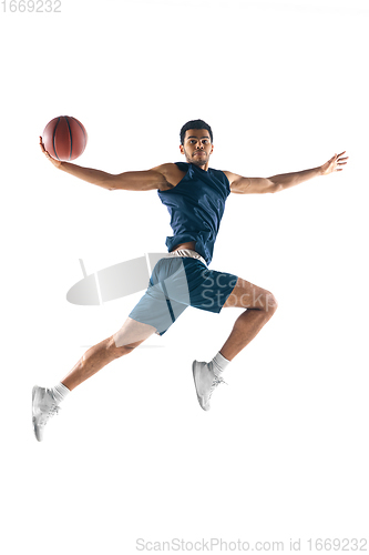 Image of Young arabian basketball player of team in action, motion isolated on white background. Concept of sport, movement, energy and dynamic.