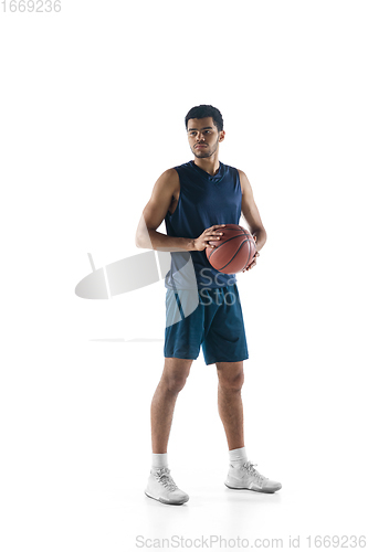 Image of Young arabian basketball player of team posing isolated on white background. Concept of sport, movement, energy and dynamic.