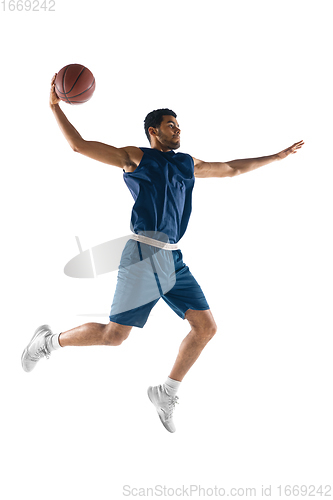 Image of Young arabian basketball player of team in action, motion isolated on white background. Concept of sport, movement, energy and dynamic.