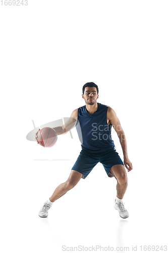 Image of Young arabian basketball player of team in action, motion isolated on white background. Concept of sport, movement, energy and dynamic.