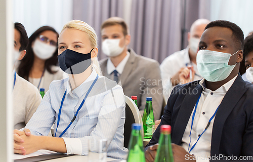 Image of business people in masks at worldwide conference