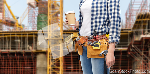 Image of woman with takeaway coffee cup and working tools