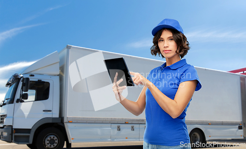 Image of delivery girl with tablet computer over truck