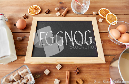 Image of eggnog word on chalkboard, ingredients and spices