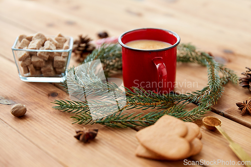 Image of cup of eggnog, fir branches, gingerbread and sugar